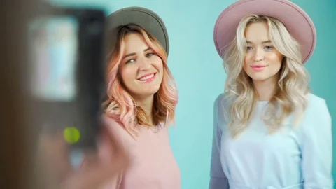 Two model girls are posing for a photographer in gentle dresses. Stock-Footage 76429906