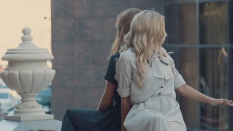 Two models of the girl sit on the gothic railing. Urban fashion. Stock Footage 104235007
