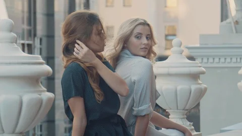 Two models of the girl sit on the gothic railing. Urban fashion. Stock Footage 104237035