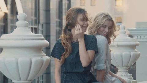 Two models of the girl sit on the gothic railing. Urban fashion. Stock Footage 104238276