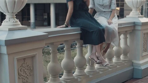 Two models of the girl sit on the gothic railing. Urban fashion. Stock Footage 104239851