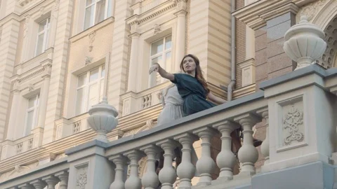 Two models of the girl sit on the gothic railing. Urban fashion. Stock Footage 104247441