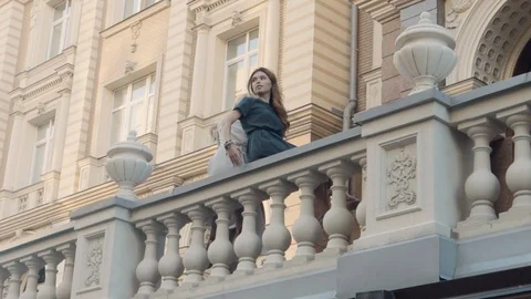 Two models of the girl sit on the gothic railing. Urban fashion. Stock Footage 104481393