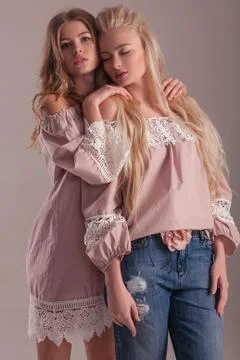 Two models posing on pink background. Stock Photos
