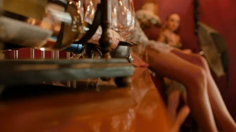 Two models in shiny dresses for a photo shoot. girl sitting on the bar table Stock Footage 107674674