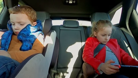 Two modern and technology children playing with smartphones in the car. Go Pro8 Stock Footage 126124533