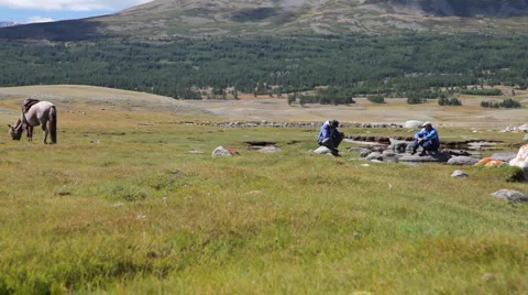 Two mongolian men at coastline  Stock Footage 1031811