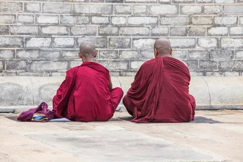 Two monks praying Stock Photos