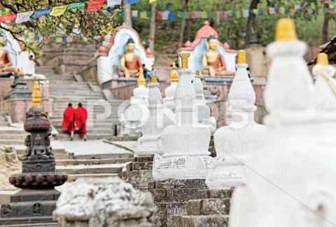 Two monks in red going upstairs swayambhunath (monkey temple) Stock Photos