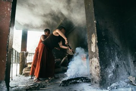 Two monks setting bonfire Stock Photos