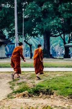 Two monks walking in a park Stock Photos