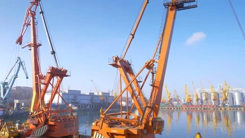 Two moored floating cranes stand in the port in anticipation of a tugboat. 4K. Stock Footage 84313324