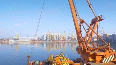Two moored floating cranes stand in the port in anticipation of a tugboat. 4K. Stock Footage 84314524
