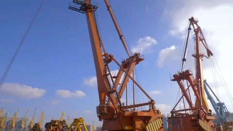 Two moored floating cranes stand in the port in anticipation of a tugboat. 4K. Stock Footage 84318091
