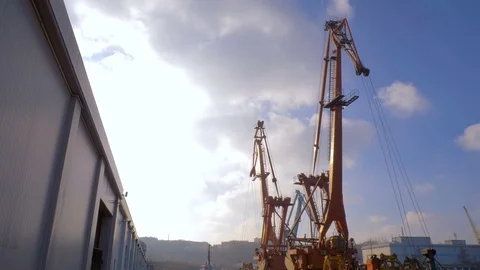 Two moored floating cranes stand in the port in anticipation of a tugboat. 4K. Stock Footage 84318990