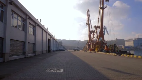 Two moored floating cranes stand in the port in anticipation of a tugboat. 4K. Stock Footage 84320200