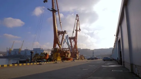 Two moored floating cranes stand in the port in anticipation of a tugboat. 4K. Stock-Footage 84322501