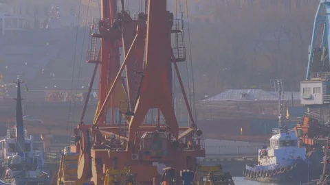 Two moored floating cranes stand in the port in anticipation of a tugboat. 4K. Stock Footage 84325127