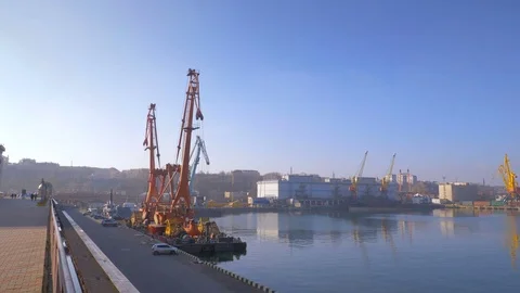 Two moored floating cranes stand in the port in anticipation of a tugboat. 4K. Stock Footage 84327448