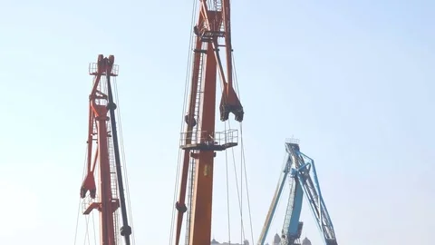Two moored floating cranes stand in the port in anticipation of a tugboat. 4K. Stock Footage 84327882