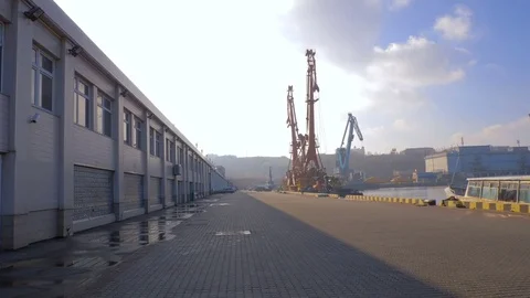 Two moored floating cranes stand in the port in anticipation of a tugboat. 4K. Stock Footage 84328429