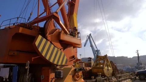 Two moored floating cranes stand in the port in anticipation of a tugboat. 4K. Stock Footage 84328706