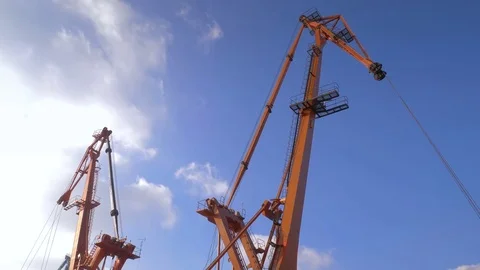 Two moored floating cranes stand in the port in anticipation of a tugboat. 4K. Stock Footage 84330422