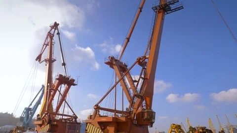 Two moored floating cranes stand in the port in anticipation of a tugboat. 4K. Stock Footage 84330831