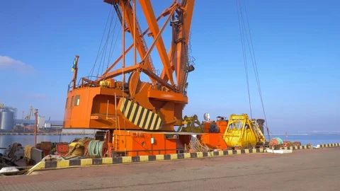 Two moored floating cranes stand in the port in anticipation of a tugboat. 4K. Stock Footage 84331662