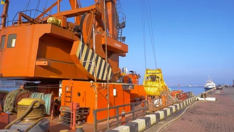 Two moored floating cranes stand in the port in anticipation of a tugboat. 4K. Stock Footage 84333563