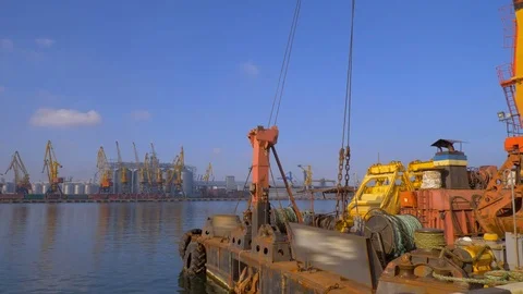 Two moored floating cranes stand in the port in anticipation of a tugboat. 4K. Stock Footage 84334268