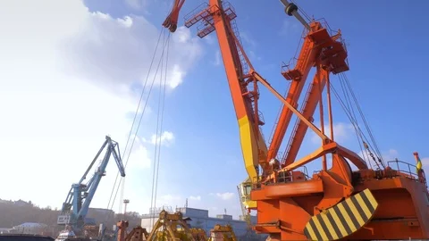 Two moored floating cranes stand in the port in anticipation of a tugboat. 4K. Stock Footage 84336262