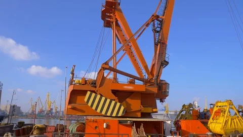 Two moored floating cranes stand in the port in anticipation of a tugboat. 4K. Stock Footage 84338340