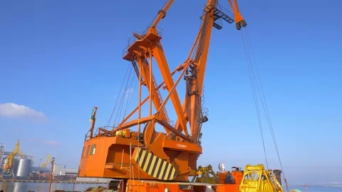Two moored floating cranes stand in the port in anticipation of a tugboat. 4K. Stock Footage 84340205