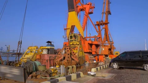 Two moored floating cranes stand in the port in anticipation of a tugboat. 4K. Stock Footage 84341502