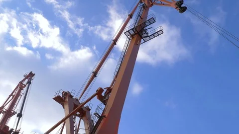 Two moored floating cranes stand in the port in anticipation of a tugboat. 4K. Stock Footage 84342861