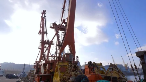 Two moored floating cranes stand in the port in anticipation of a tugboat. 4K. Stock Footage 84344110