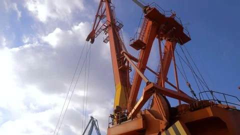 Two moored floating cranes stand in the port in anticipation of a tugboat. 4K. Stock Footage 84345274