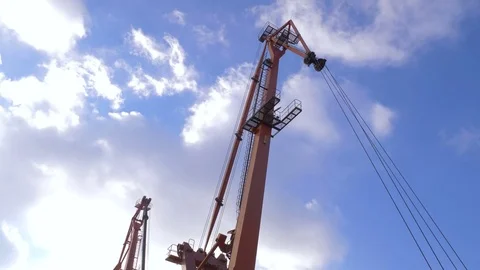 Two moored floating cranes stand in the port in anticipation of a tugboat. 4K. Stock Footage 84346260