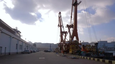 Two moored floating cranes stand in the port in anticipation of a tugboat. 4K. Stock Footage 84347265