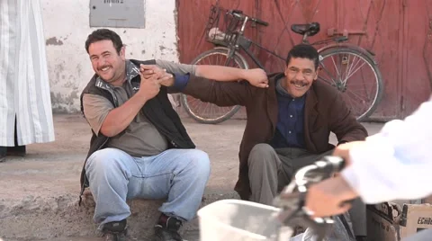 Two Moroccan men playing tricks to one another Stock Footage 49678868