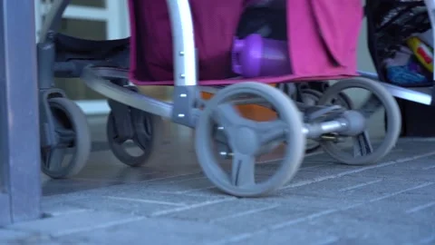 Two mothers with strollers enter the mall Stock Footage 156170292
