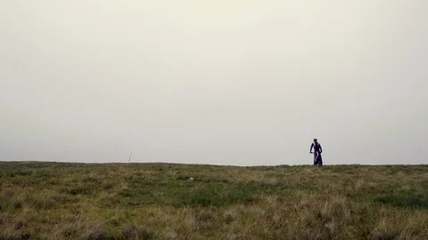 Two motocross riders going over the horizon and into the mist. 4K Stock Footage 94353499