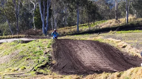 Two Motocross Riders Navigate Dirt Track Jump in Australia Vídeo Stock 317076933