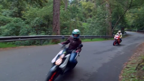 Two motor bikers driving fast on the street Видео 75167156