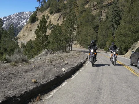Two Motorcycle riders on a Mountain highway Stock Footage 76874253