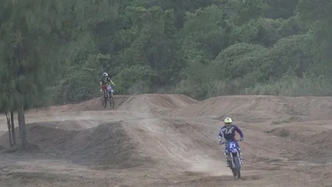 Two motorcyclists approaching, one after another, front view Stock Footage 130913548