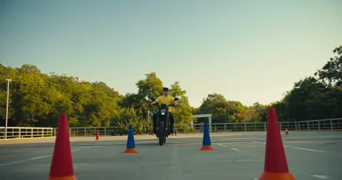 Two motorcyclists go to different sides at the training ground in a motorcycle Stock Footage 249234728