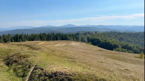 Two motorcyclists quickly descend the mountain road towards the forest Stock Footage 285345073