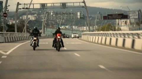 Two motorcyclists ride on the highway on camera Video stock 114555767